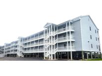 Three-story building with multiple balconies and parking underneath at 310 Marsh Pl. # 312, Murrells Inlet, SC 29576