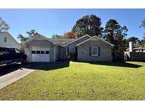 Brick ranch home with attached garage and well-maintained lawn at 319 Rice Mill Dr., Myrtle Beach, SC 29588