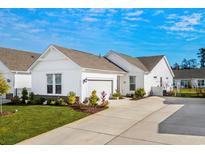 White house with gray roof, landscaping, and a two-car garage at 4036-D Taranto Loop # 5404-D, Myrtle Beach, SC 29579