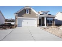 New construction home with a neutral exterior, two-car garage, and stone accents at 432 Hallie Martin Rd., Conway, SC 29527