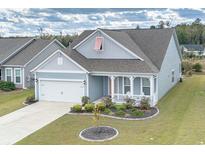 Gray siding house with white accents, landscaping, and a two-car garage at 208 Angel Wing Dr., Myrtle Beach, SC 29588