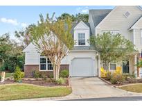 Attractive exterior of a two-story townhome with a brick facade and landscaping at 140 Wimbledon Way # 140, Murrells Inlet, SC 29576