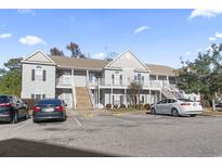 Two-story building with ample parking and surrounding trees at 220 Portsmith Dr. # 7, Myrtle Beach, SC 29588