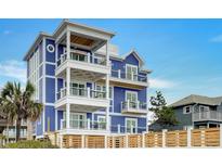 Stunning three-story beach home with multiple balconies and white accents at 219 South Seaside Dr., Surfside Beach, SC 29575