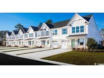 Row of charming townhouses with white exteriors and landscaping at 301 Bent Green Ct. # 84F, Murrells Inlet, SC 29576