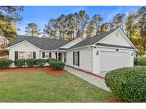 White house with gray roof, two-car garage, and landscaped lawn at 3604 Farmington Pl., Myrtle Beach, SC 29579