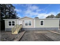 Attractive manufactured home with stone accents and a wooden staircase at 3641 Wayside Rd., Conway, SC 29527