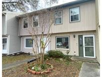 Two-story townhouse with light pink siding, green door, and small front yard at 55 Freedom Way # 55, Myrtle Beach, SC 29577