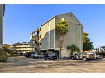 Exterior view of Golf Glen Villas, showing building and parking lot at 1101 Possum Trot Rd. # A103, North Myrtle Beach, SC 29582