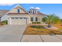 Beautiful two-story home with a charming front porch and landscaping at 2017 Silver Spring Ln., Myrtle Beach, SC 29577