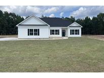 Newly constructed home with white siding, black windows, and a gray roof at 217 Shady Pines Ct., Conway, SC 29527