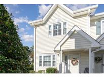 Inviting two-story townhome with light yellow siding and a charming front porch at 101 S Barnwell St. # 38-A, North Myrtle Beach, SC 29582