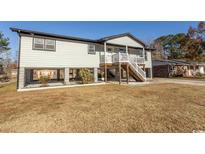 Elevated home with spacious yard, modern exterior and covered porch at 4730 Cottonwood Dr., Myrtle Beach, SC 29588