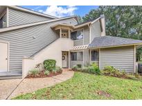 Gray siding condo with stairs leading to entrance, landscaping, and a grassy area at 101 Westhill Circle # 5-C, Myrtle Beach, SC 29572