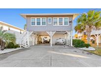 Charming elevated beach home with boat parking and spacious front yard at 310 46Th Ave. N, North Myrtle Beach, SC 29582