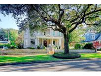 Grand two-story home with stone facade, mature trees, and a classic front porch at 116 Saint James St., Georgetown, SC 29440