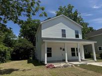 Two-story house with white siding, front porch, and landscaped lawn at 908 Merriman Rd., Georgetown, SC 29440