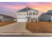 Two-story house with gray and white siding, two-car garage, and a landscaped lawn at 326 High Falls Dr., Conway, SC 29526