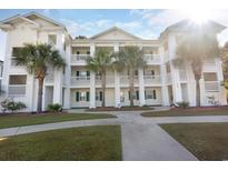 Attractive exterior of a light-colored building with palm trees and a walkway at 650 Tupelo Ln. # 5-F, Longs, SC 29568