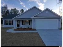 Newly constructed home with gray siding, two-car garage, and landscaping at Tbd 3 Mineral Springs Rd., Conway, SC 29527