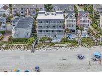 Aerial view of beachfront property showing building, pool, beach, and ocean at 1213 S Ocean Blvd. # 103, Surfside Beach, SC 29575