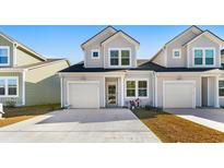 Two-story townhome with gray siding, white trim, and a two-car garage at 351 Brackish Dr. # 351, Myrtle Beach, SC 29588