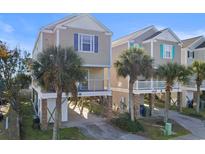 Charming beach house with palm trees and balconies at 411A Ocean Blvd. S, Surfside Beach, SC 29575