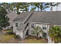 Tan two-story condo building with grey roof and palm trees at 4486 Little River Inn Ln. # 2105, Little River, SC 29566
