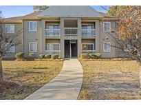 Front exterior view of a two-story condo building with balconies, walkway, and landscaping at 500 Myrtle Greens Dr. # B, Conway, SC 29526