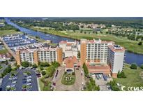 Aerial view of a large resort hotel with a marina and golf course at 8121 Amalfi Pl. # 5-103, Myrtle Beach, SC 29572