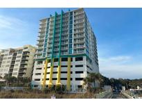 Modern high-rise building with colorful accents, parking garage, and beach access at 2301 S Ocean Blvd. # 1002, North Myrtle Beach, SC 29582