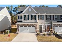 Charming two-story townhome with a one-car garage and landscaped front yard at 308 Golan Circle # C, Myrtle Beach, SC 29579