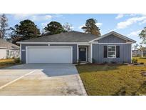 Charming blue two-story home with a two-car garage and landscaped yard at 527 Firouz Dr, Longs, SC 29568