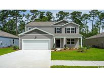 Charming two-story home with a gray exterior, white garage door, and landscaped front yard at 1179 Maxwell Dr., Little River, SC 29566