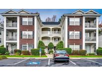 Brick building exterior with ample parking at 1286 River Oaks Dr. # 8-M, Myrtle Beach, SC 29579