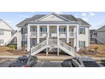Attractive two-story condo building with balconies and front steps at 4924 Pond Shoals Ct. # 101, Myrtle Beach, SC 29579