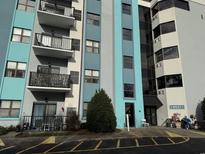 Exterior view of a multi-story condo building with balconies at 5001 Little River Rd. # W109, Myrtle Beach, SC 29577