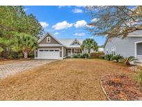 Attractive single-story home with a paved driveway and manicured lawn at 317 Goddard Ln., Murrells Inlet, SC 29576