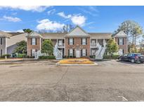 Two-story brown building with stairs and parking at 712 Algonquin Dr. # A, Pawleys Island, SC 29585