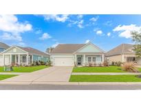 Charming light blue home with a covered porch and attached garage at 935 Piping Plover Ln., Myrtle Beach, SC 29577