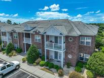 Brick building with balconies, landscaping, and ample parking at 2033 Silvercrest Dr. # 21-A, Myrtle Beach, SC 29579