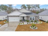 Single-story home with stone accents and a two-car garage at 4551 Day Lily Run St., Myrtle Beach, SC 29579