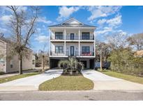Two-story home with white siding, black accents, and a spacious driveway at 505 28Th St. S, North Myrtle Beach, SC 29582
