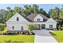 Craftsman style home with gray siding, stone accents, and a three-car garage at 1017 Muscovy Pl., Conway, SC 29526