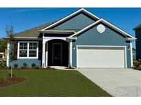 Charming one-story home with blue siding, white garage door, and well-manicured lawn at 527 Slaty Dr., Myrtle Beach, SC 29588