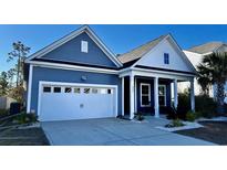 Two-story house with blue siding, white trim, and a front porch at 6223 Chadderton Circle, Myrtle Beach, SC 29579