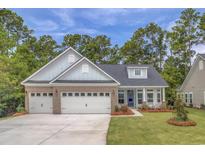 House exterior featuring a 3-car garage, brick and siding at Lot 729 Zoe Way, Myrtle Beach, SC 29588