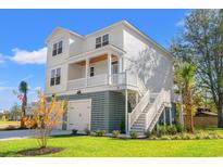 Two-story home with white siding, gray accents, and a detached garage at Tbd Mud Minnow Dr., Pawleys Island, SC 29585