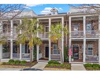 Brick townhome with front porch and American flag, inviting curb appeal at 2794 Howard Ave. # E, Myrtle Beach, SC 29577