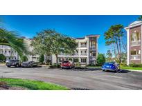 Two-story condo building with ample parking and landscaping at 1192 River Oaks Dr. # 28-B, Myrtle Beach, SC 29579